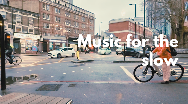 A street view with cars and bicycle with the text 'Music for the slow' superimposed